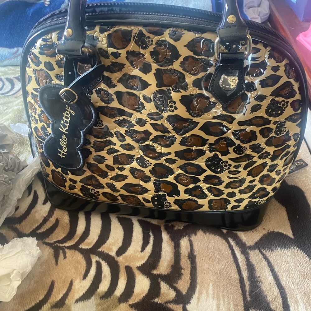 Hello kitty bowling bag cheetah print comes with dust bag has some scuffs on it.